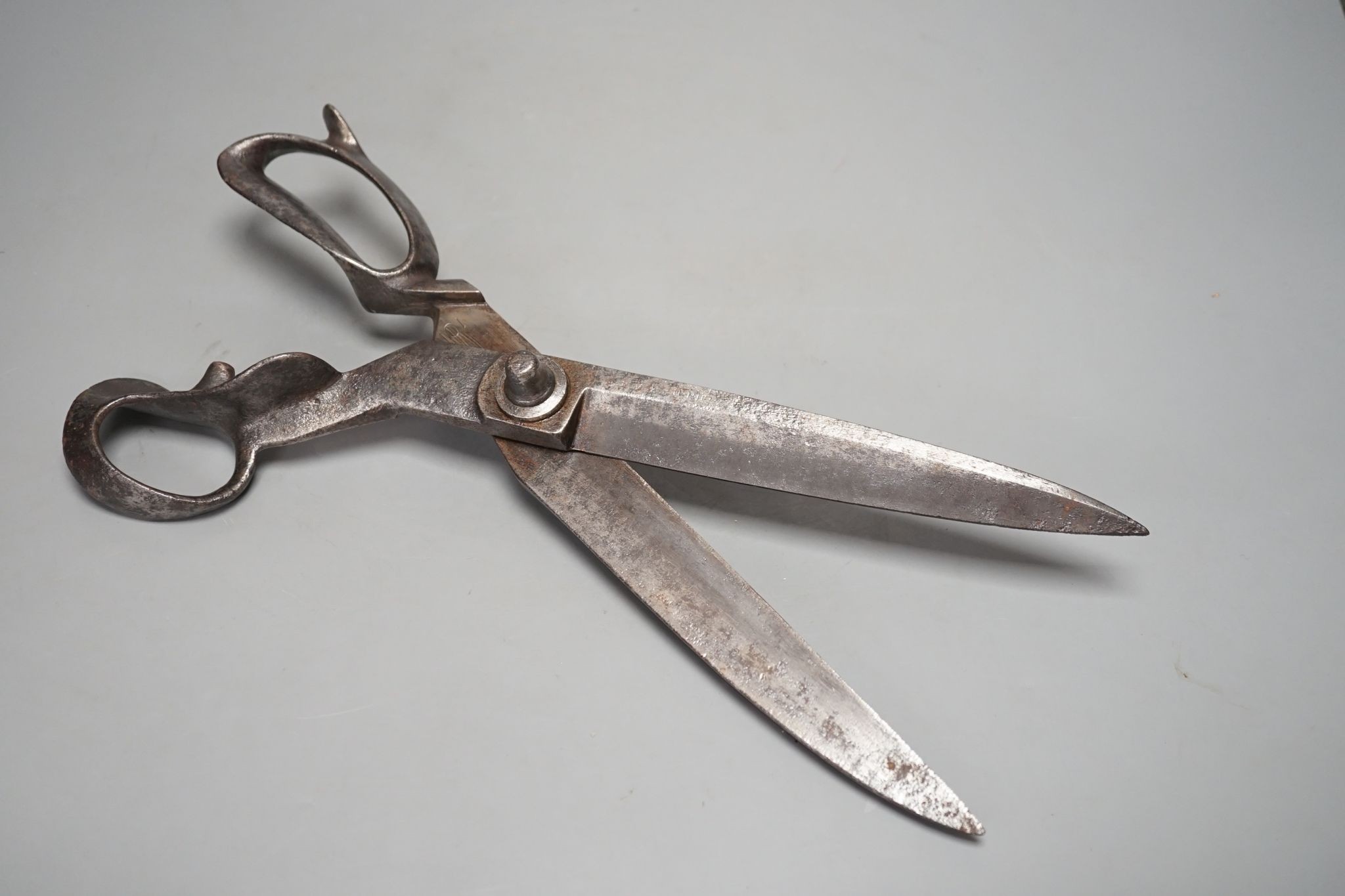 A pair of over-sized tailor’s scissors, one blade stamped ‘1938 \ 5110.99.910.5934’